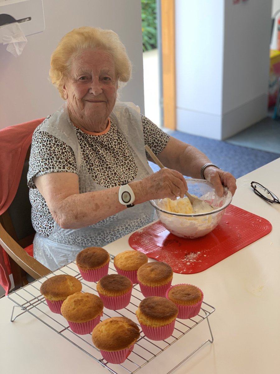 Marion smiling while stirring up some icing for her cupcakes