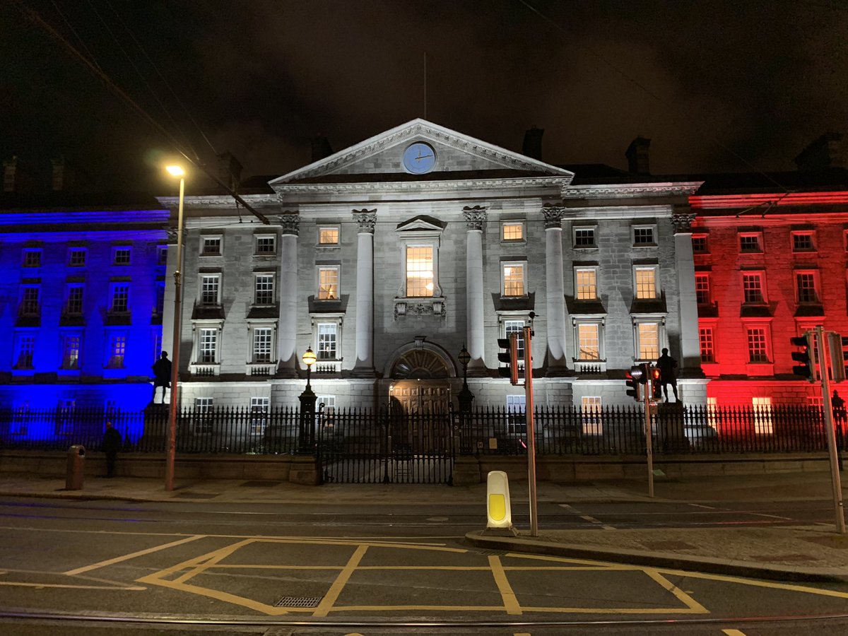 Front view of Trinity at night with French flag superimposed in lights on the front.