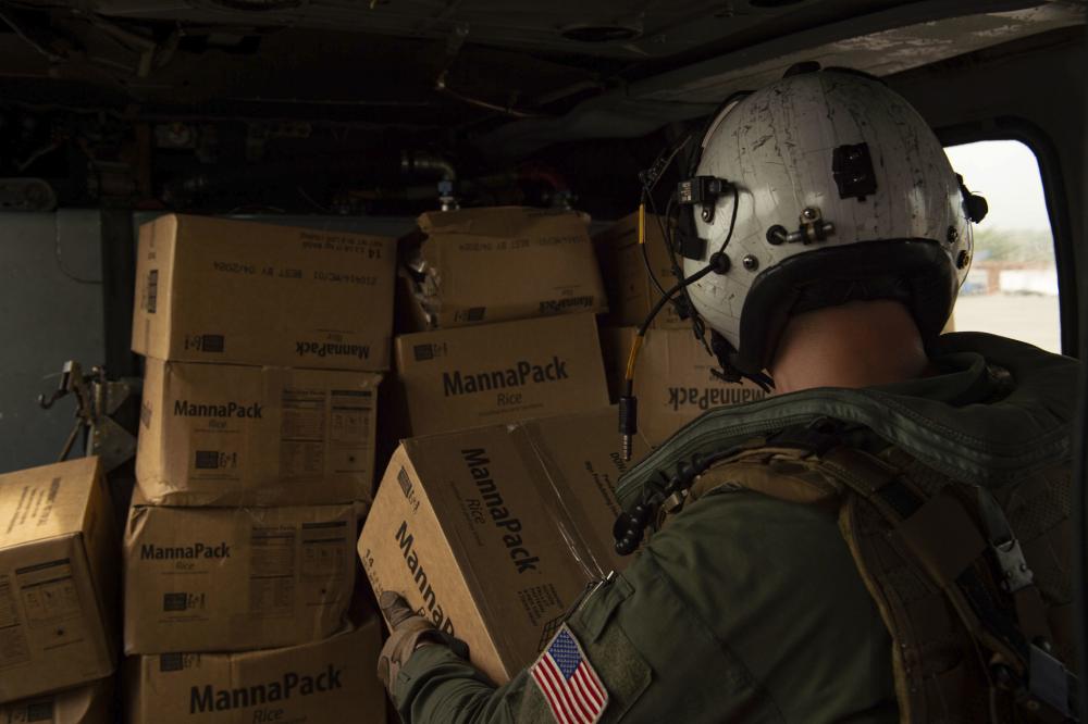 Haitian citizens receive boxes of food delivered by the #Chargers of #HSC26, attached to the amphibious transport dock ship USS Arlington #LPD24. Arlington is underway in the Caribbean Sea to support humanitarian relief efforts in Haiti. #JTFHaiti #HaitiEarthquake