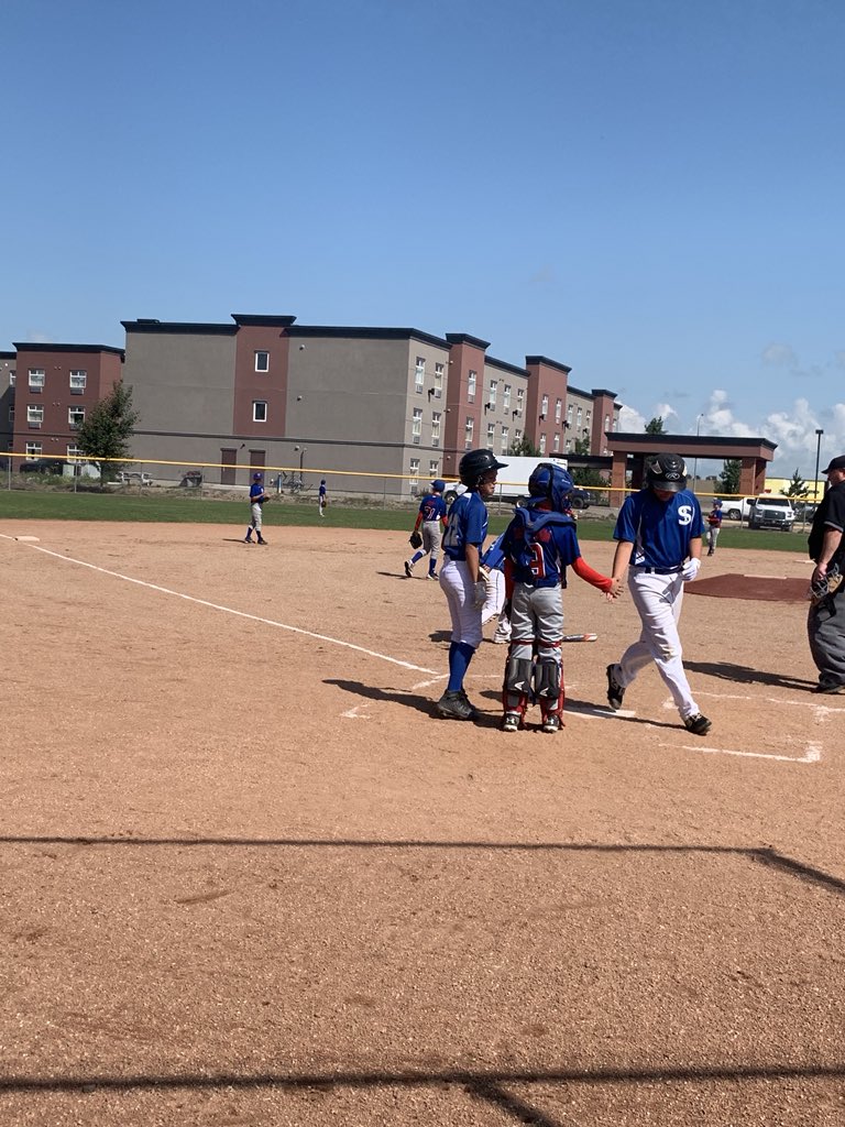 MLMinorBall's tweet photo. What a picture! James Norman just crushed a home run putting the game out of reach for @CubsfromLumsden. Great sportsmanship by this young catcher! Well done Lumsden! #sportsmanship @BaseballSask https://t.co/h9sHjg2f4X