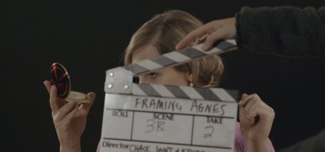 woman holding compact and clapboard in front