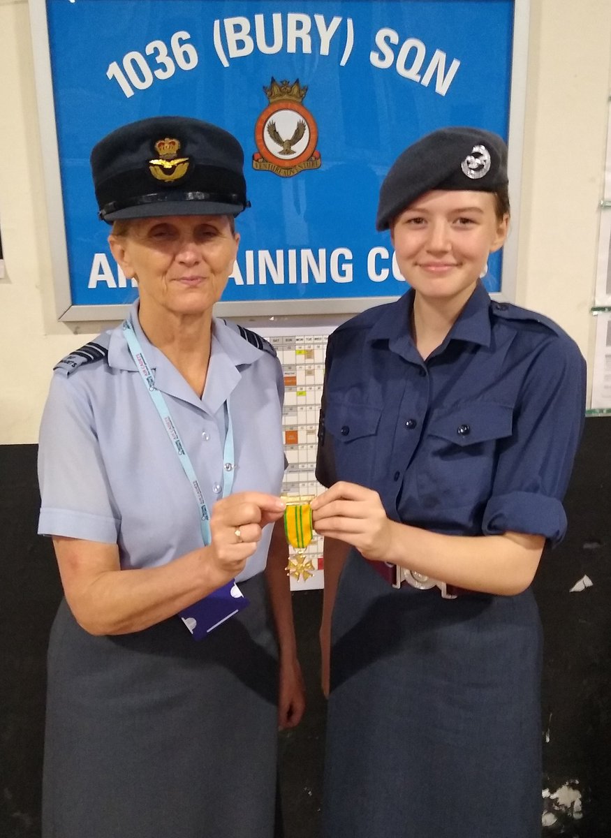 Cdt Ellie Sutton is presented with her Nijmegen medal by OC 1036 Flt Lt Liz Thomas.