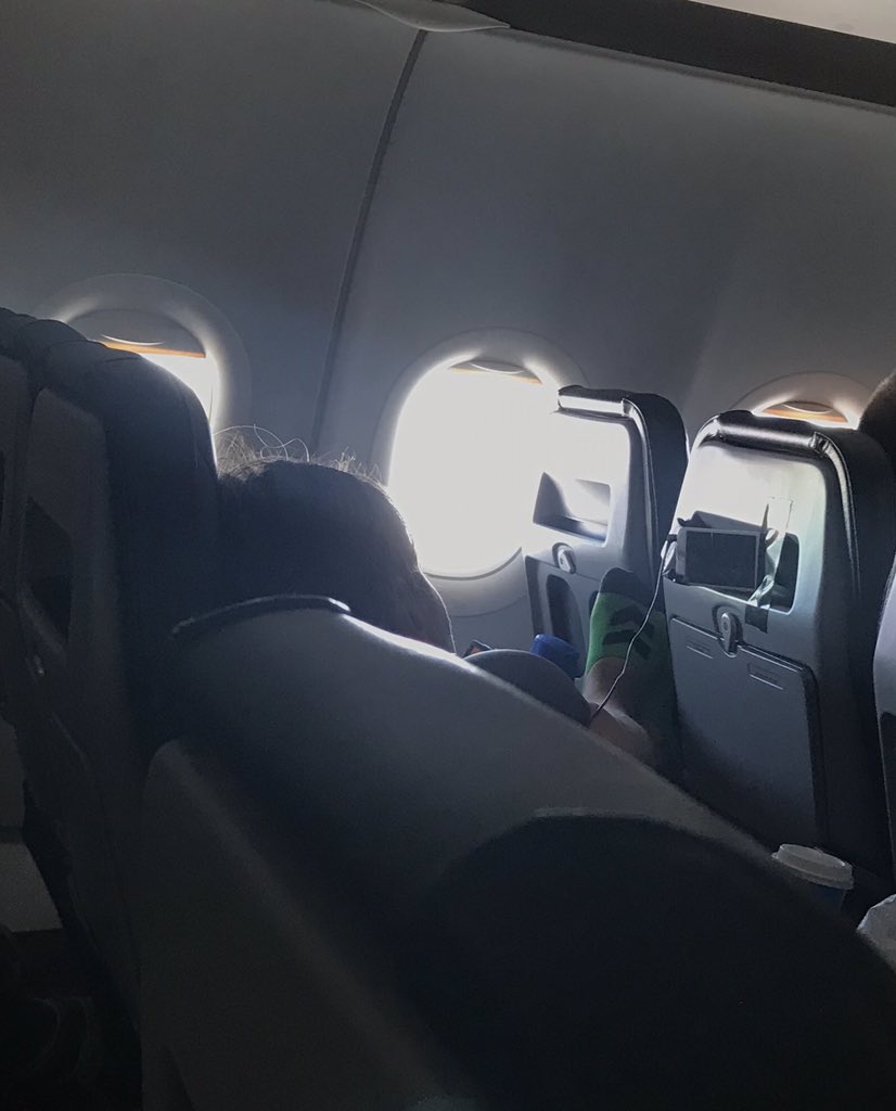 @JonCampbellGAN I took this on a flight last week. This was after she had been told by the flight attendant that her feet were in the face of the man whose chair that is. Notice also the taped up phone on the seat back #passengershaming