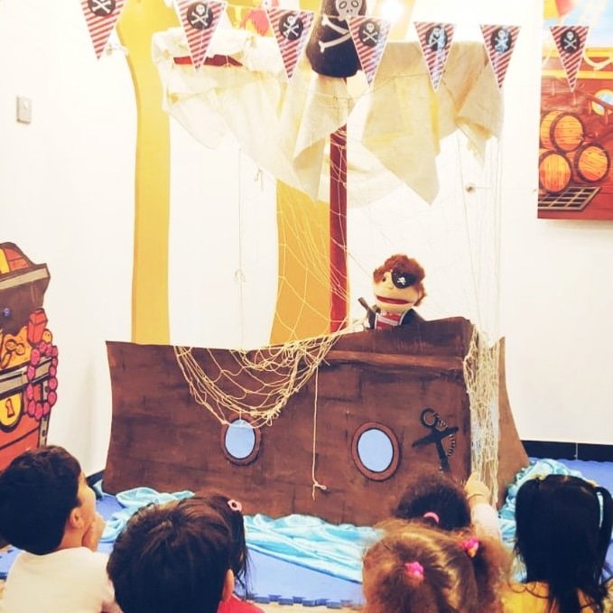 CESKonline's tweet photo. Pirate Jack is telling our Summer Campers a tall tale about his amazing pirate adventures! #storytimefun #storytime #youngreaders #dohafun #qatarnursery #bestnurserydoha #summercampqatar #qatarsummer #qatarfamily #dohafamily #dohamoms #qatarliving #qatarlife #thingstodoindoha https://t.co/62CQ8wPaXg