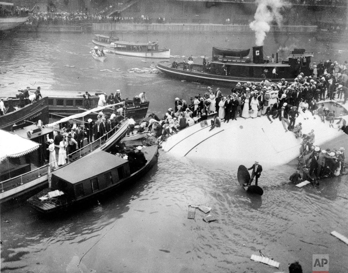 AP_Images's tweet photo. #OTD in 1915, the SS Eastland, a passenger ship carrying more than 2,500 people, rolled onto its side while docked at the Clark Street Bridge on the Chicago River; an estimated 844 people died in the disaster. https://t.co/MS95FrYK1Z