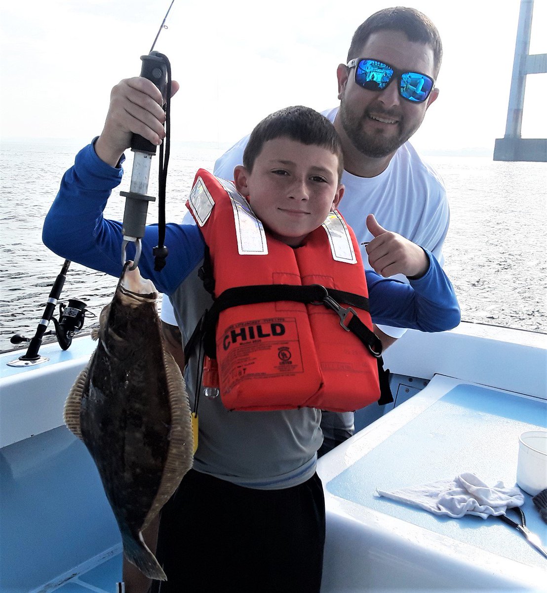 CaptDaveMonti's tweet photo. First keeper fluke: Aiden Coulombe (seven) of Massachusetts and his father Peter with fist keeper fluke he caught at the Newport Bridge last week. https://t.co/BZDk6EcFWJ