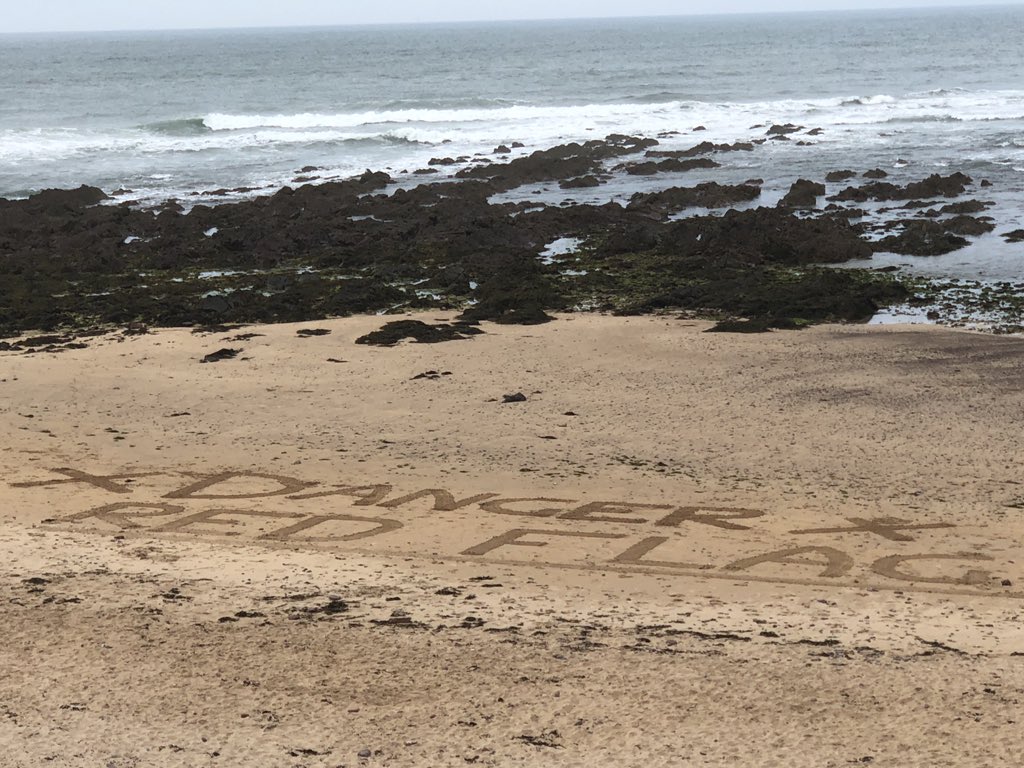 dirtycash's tweet photo. Great work by @RNLI lifeguard Charlie. The #HEATWAVE2019 has certainly kept the lifeguards at #freshwaterwest very busy and this is great way to draw attention to the red flags 🚩 on the beach. https://t.co/Xgt0RWWB0g