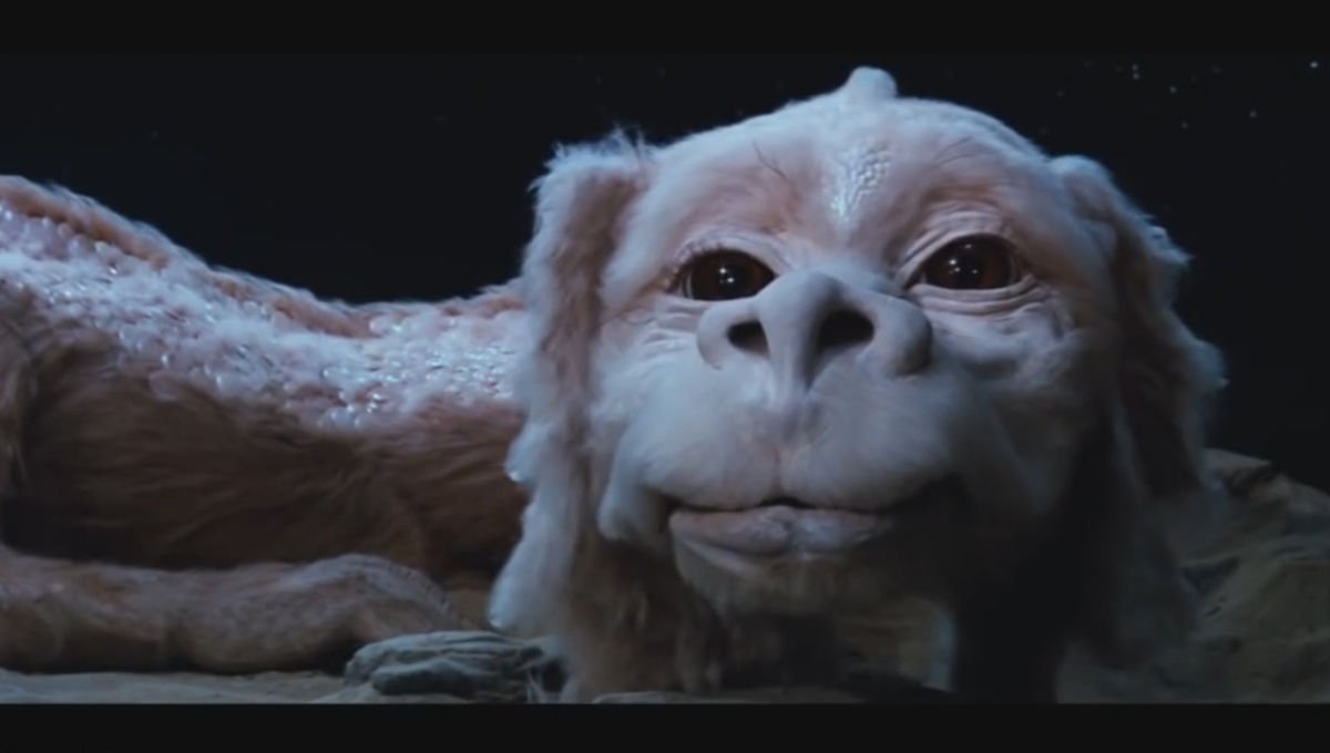 dragons_let's tweet image. #Day29 Falkor. He is a luckdragon that first appeared in the 1979 novel The Neverending Story by Michael Ende. He's the companion of Atreyu and Bastian. He's friendly and optimistic and has an elongated body with pink/white scales. What do you think of this helpful dragon?