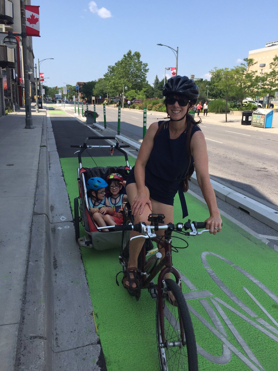 LdnCycleLink's tweet photo. Meet Kelly who bikes with her two kids on the King St @LdnOntBikeLane. She says she feels safer with the new protected bike lane and it’s “a step in the right direction”. She’d like to see a safe way to bike west through downtown as well. #ldnont #completestreets #citiesforpeople https://t.co/W0fSJ5bb5y