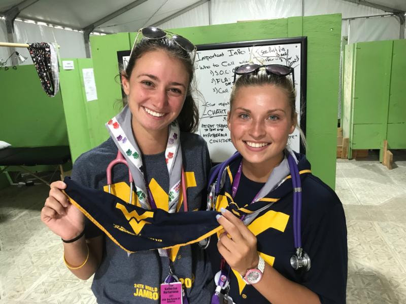 WVUSoN's tweet image. Approximately 19 @WVUSoN students, including Katherine Barbarossa (left) and Morgan Spoharski, and four @WVUSoN faculty are volunteering for the next two weeks at the @2019_wsj More than 50,000 scouts from 150 countries are expected. #ScoutJamboree #WVU #Nurses