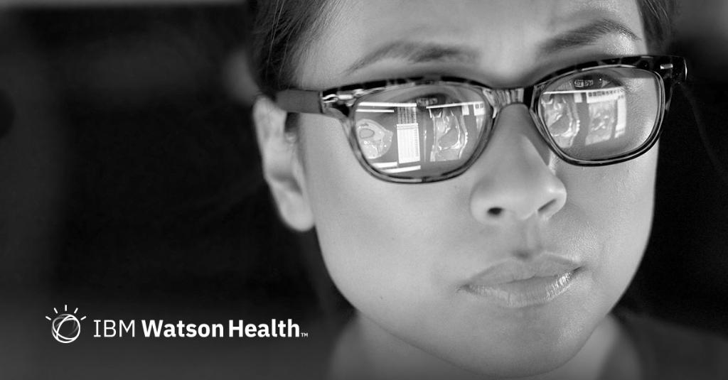 woman with glasses looking at screen