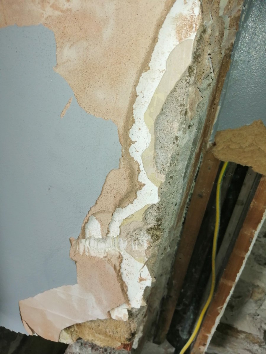 Here's some horrible paint trapping moisture on gypsum plaster on top of soft lime. Vinyl paint, masonry paint, silk paint, and gloss paint should all be avoided.  Aim for lime based, clay based, water based or linseed based paints to allow breathability of lime work and woodwork