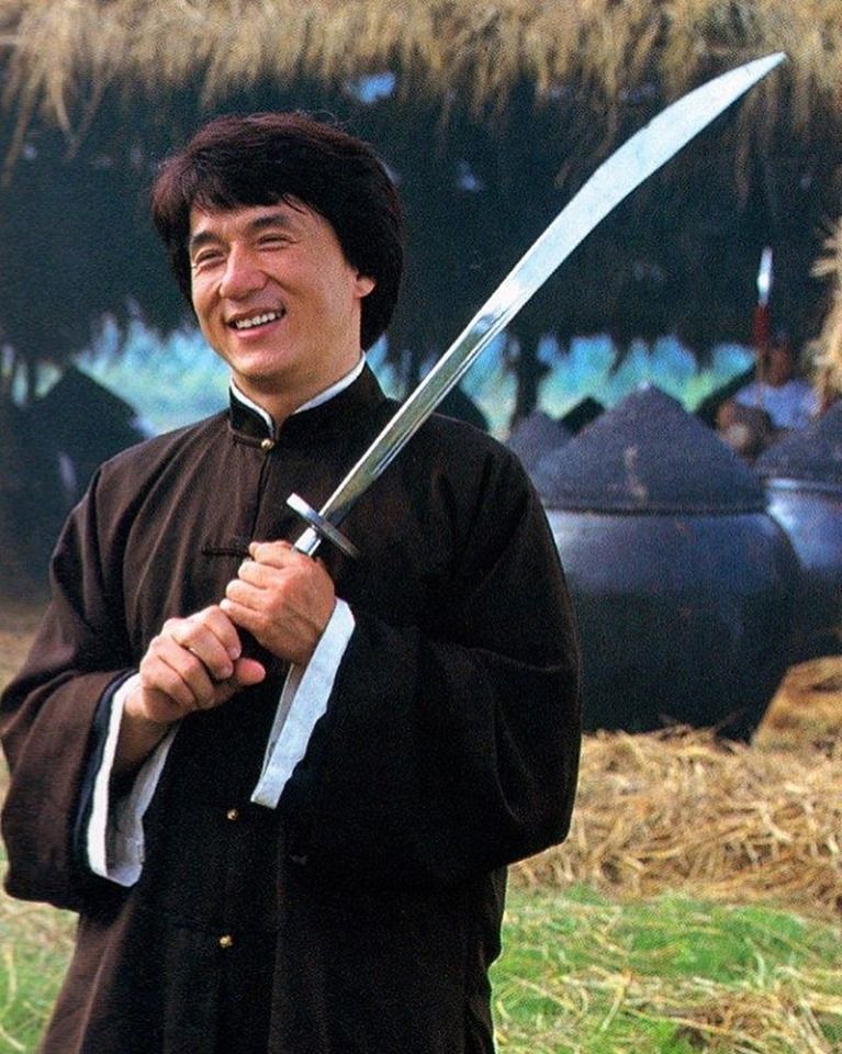 Jackie Chan holding a dao