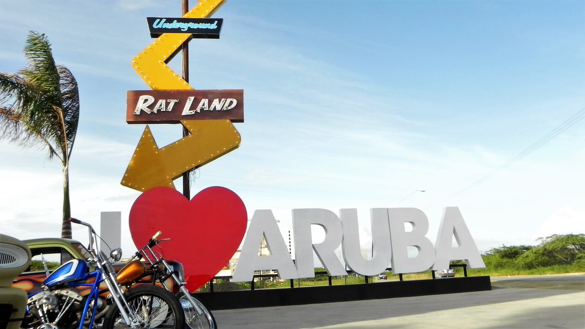 PHOTO of Rat Land sign, long gone, with "I Heart Aruba" portable sign behind it.
