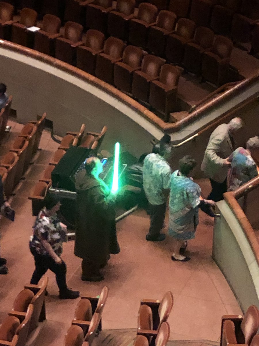 BioChromatic's tweet photo. @JoelOtron Even better the conductor borrows a lightsaber from a cosplayer and uses it to conduct! https://t.co/UUD4yVCCUl