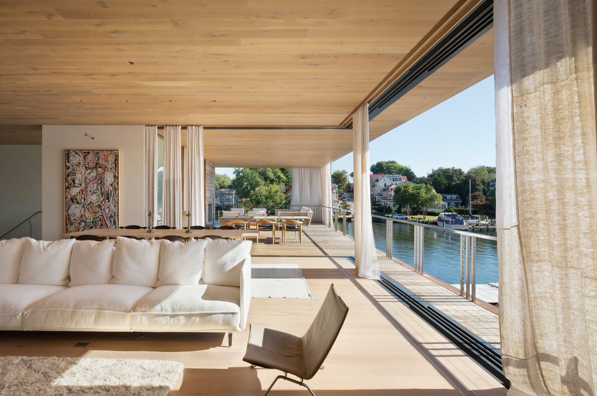 Breezy open air living space connected to a cantilevered balcony with views of the Chesapeake Bay waterfront in Annapolis, Maryland