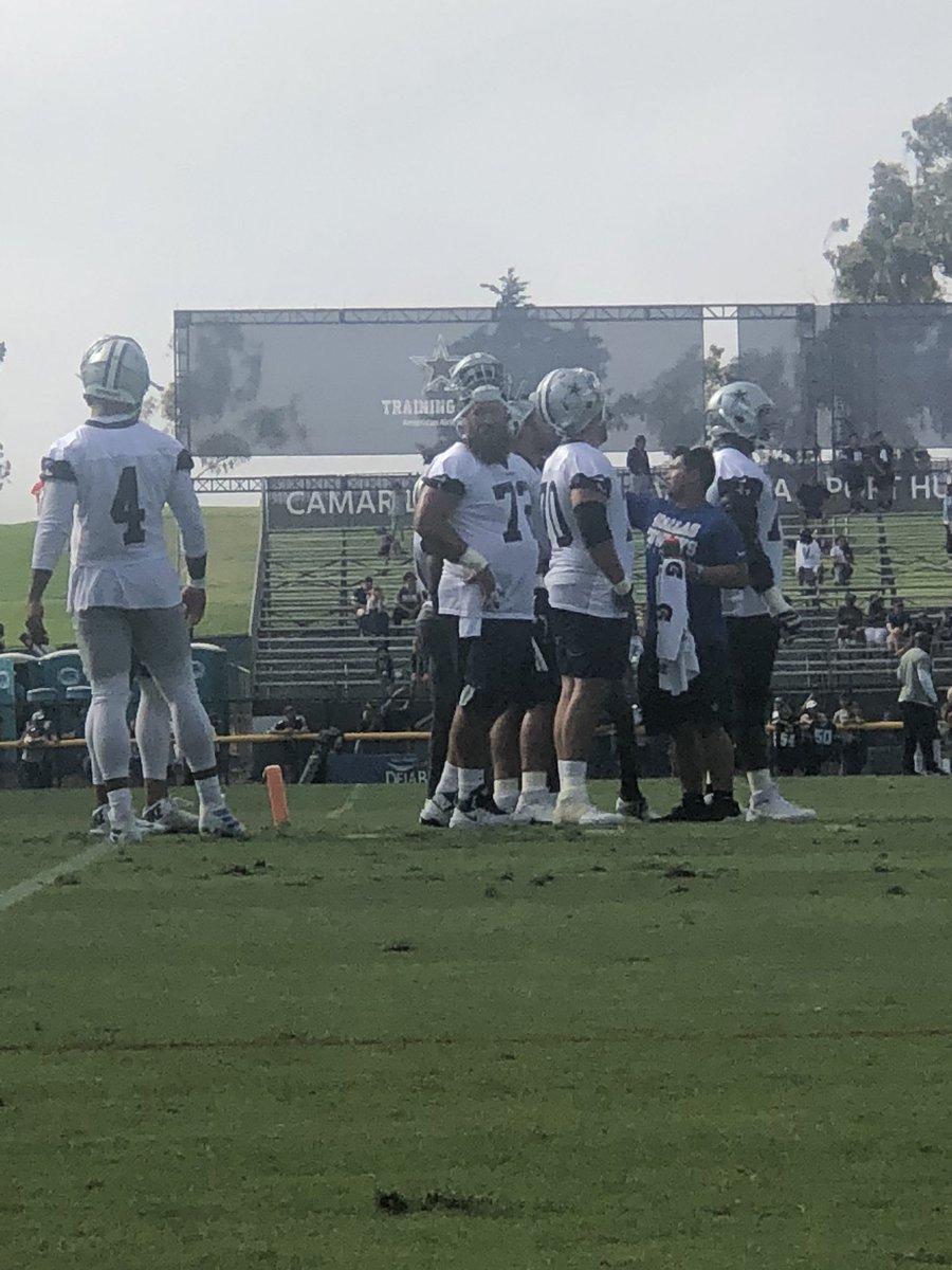 davehelman_'s tweet photo. this is what a normal-sized person looks like in the huddle with the Dallas Cowboys’ O-Line https://t.co/T029mqonzR