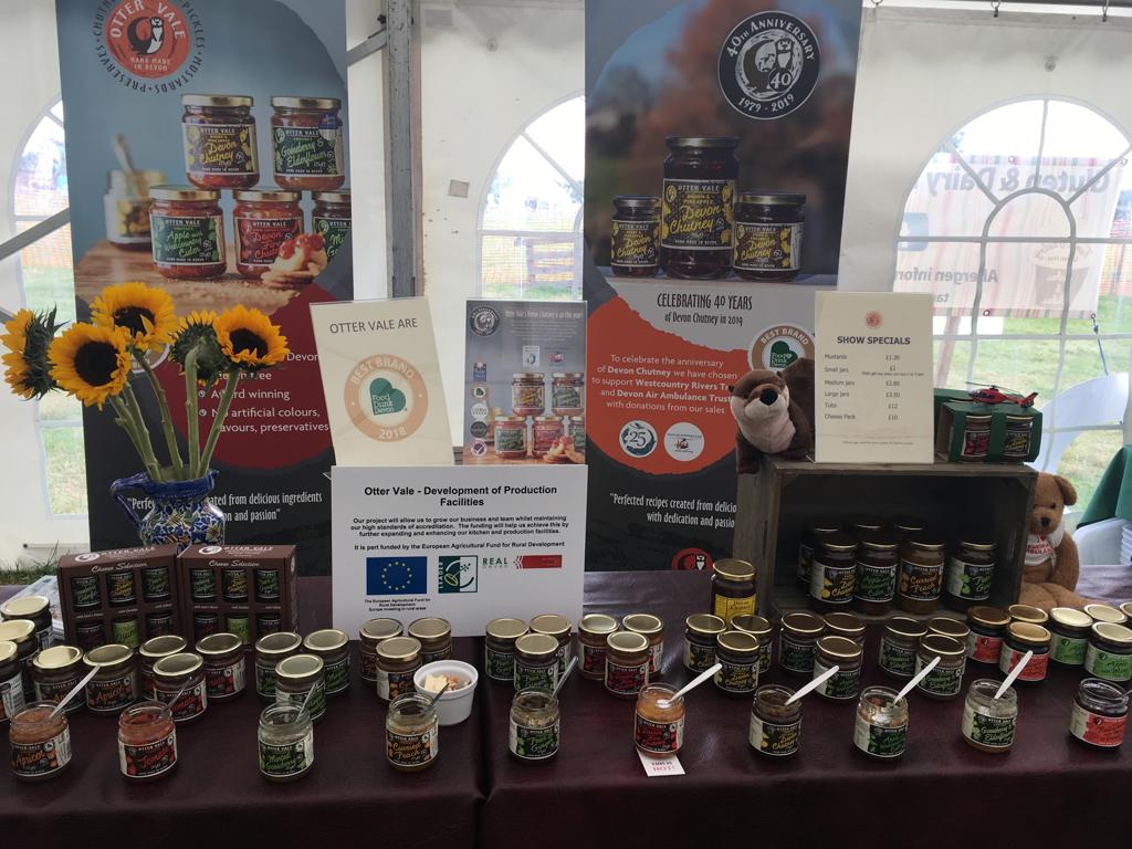 OtterVale's tweet photo. Granny #OtterVale is at the #WoolseryShow today. Come & say hello; try some of our #glutenfree #chutneys, #jellies, #marmalades & more. Find out how #40y of our #DevonChutney is supporting @DevonAirAmb & @WestcountryRT.
#Devon #DevonFood #supportlocal #40th #Woolsery https://t.co/h62ot1ImpD