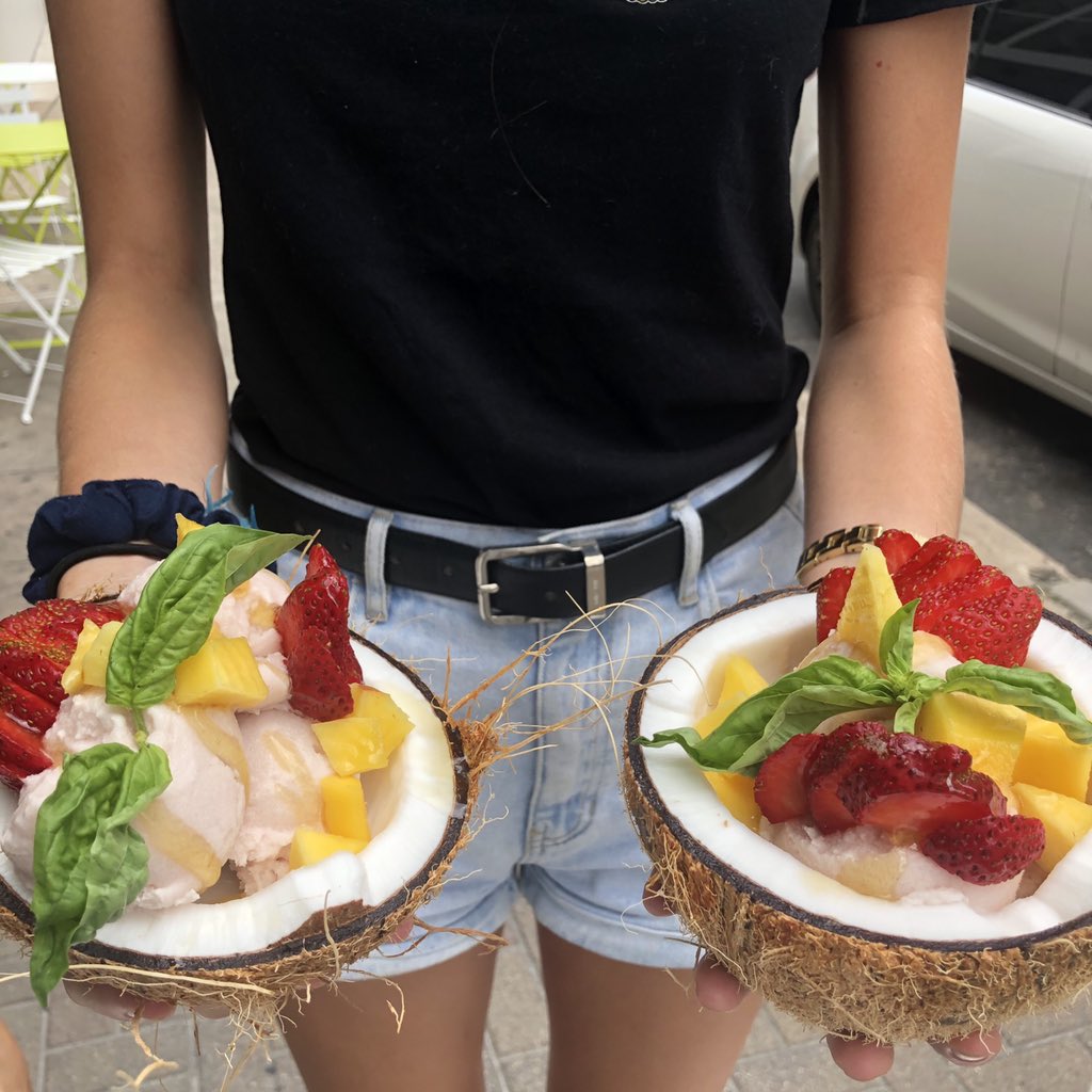 açaí ice cream bowls with fresh fruit, a honey drizzle and served inside a halved coconut