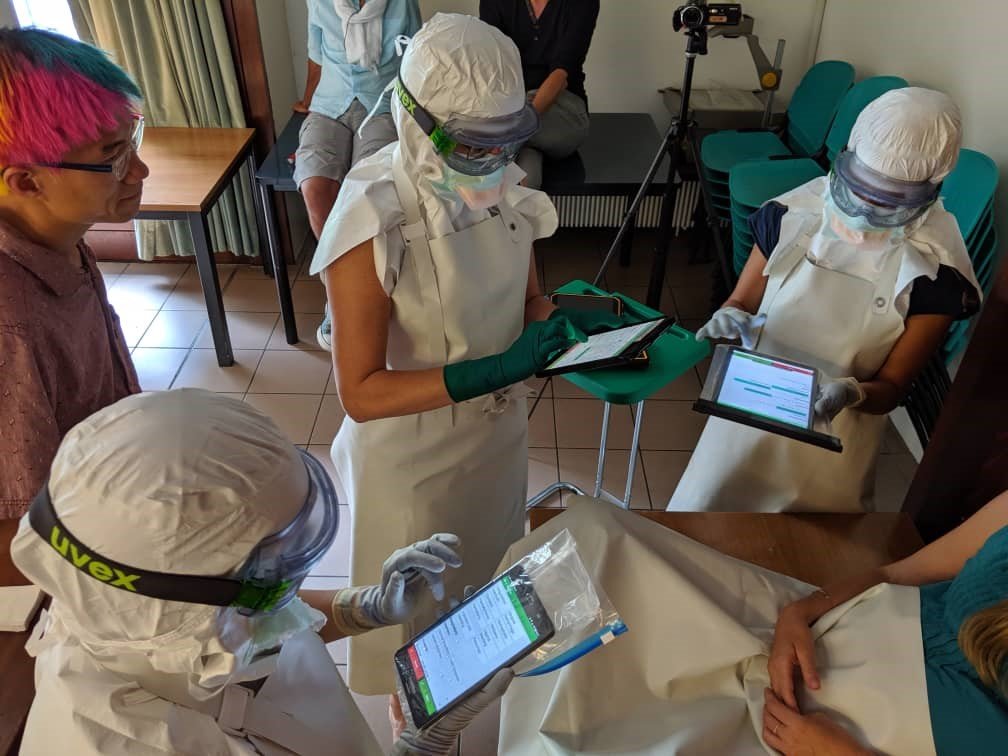 Medic testing in partial personal protective equipment (PPE) of the Buendia Mini-EHR at MSF Operational Center Geneva (OCG) in early July 2019. Please note that short sleeves are not worn in full PPE conditions. Image credit: Eric Perakslis