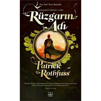 ECizgiler's tweet photo. "Rüzgarın Adı" kitap kapağı betimlemesi: En tepede "New York Times Bestseller" ve onun hemen altında "Kral Katili Güncesi 1. Gün" yazıyor. Sayfayı tam ortalayan yuvarlak altın renk çerçeveli bir resim var. https://t.co/nT6nMT5zth
