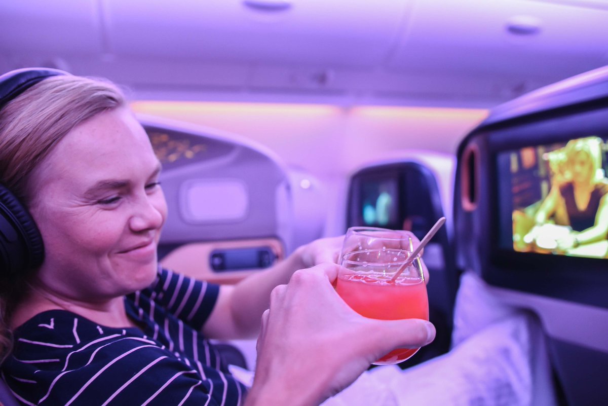 BackstreetNomad's tweet photo. Cheers! Enjoying cocktails with our big screen and lie flat seats (not fully reclined yet) in @SingaporeAir business class. This was the last flight of the #squadsq adventure and we couldn't have asked for a better time or company. #flysq https://t.co/OwTEsR3TJa
