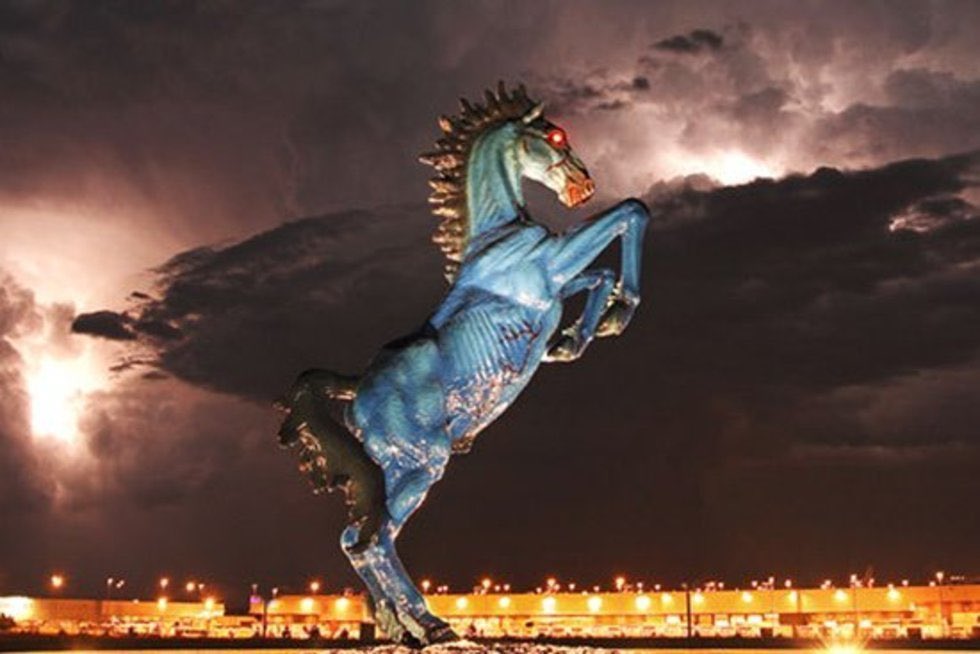 denver airport horse statue at night with imposing storm clouds