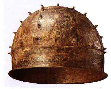 The only Bandhelm that has this feature is the one from Groningen, which dates to some time between the 6th and 8th centuries. So the influence can't come from bandhelmets.