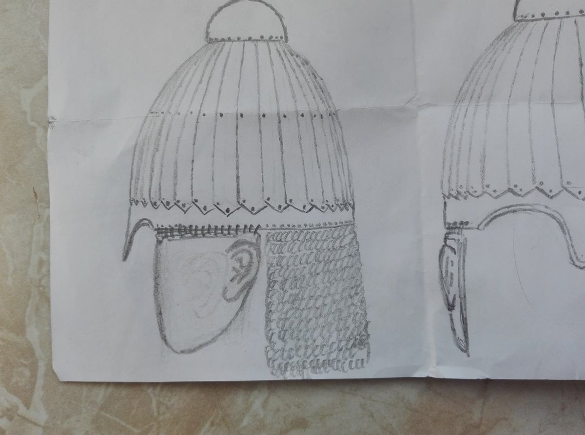 I think it's sufficiently obvious that one of the helmet types we see is the early 5th century Kalkhni-type Lamellenhelm, which is believed to have had cheekpieces with shaped ears, like Roman cavalry helmets.
