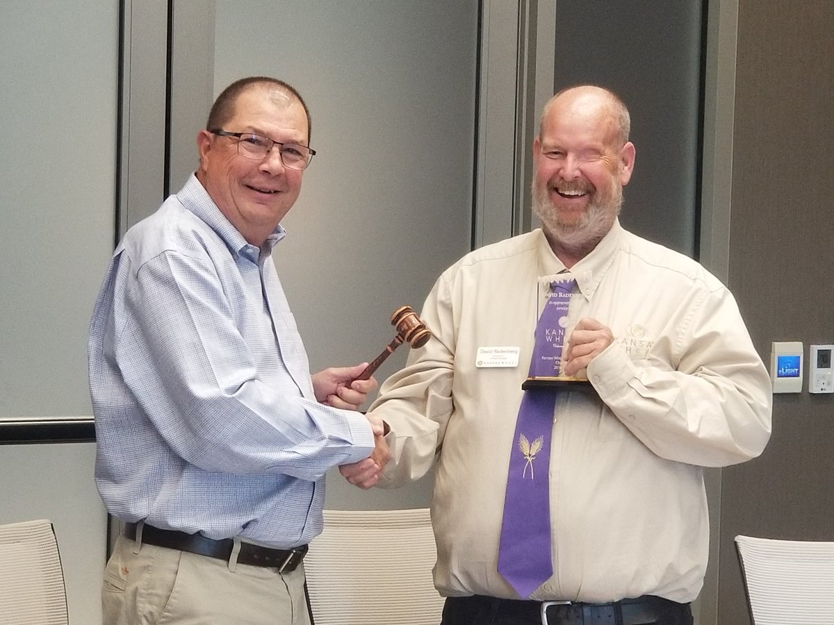 Outgoing Chairman David Radenberg passes the gavel to incoming Chairman Mike McClellan during the Kansas Wheat Commission board meeting today in Wichita.