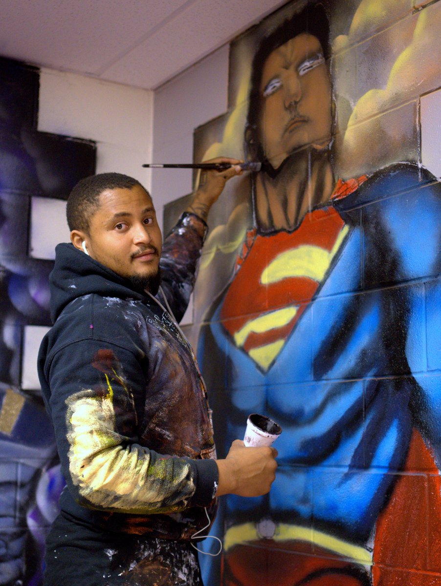 CafeBaso's tweet photo. South side artist Barrett Keithley completing his Black Super Hero's mural at the Jesse White Learning Academy in Hazel Crest, Il. https://t.co/F506DYcmDb