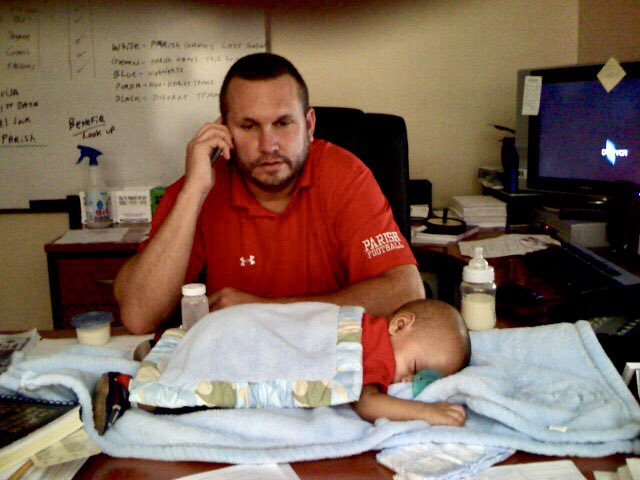 CoachNady's tweet photo. A friend sent me this pic today as my son starts 4th grade. 11 yrs. ago I was building a football program from scratch & using my office desk as a day bed for Max while I called college coaches. “Coach I have a linebacker you must see! Give me a second to burp my son.” #HustleN https://t.co/Nqv5O4Zrq9