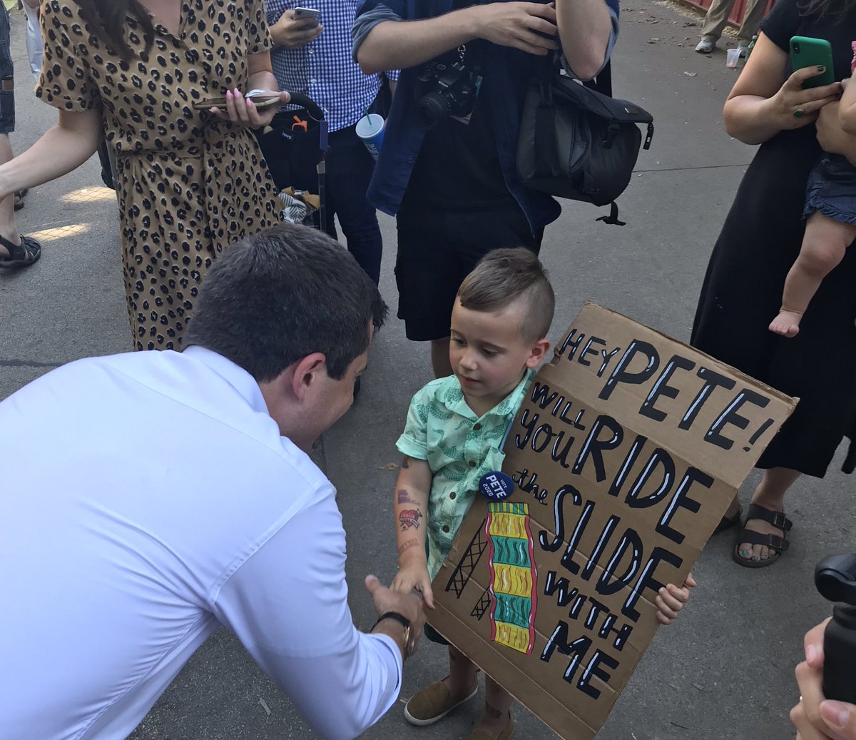 bcrodriguez's tweet photo. .@PeteButtigieg prepares to ride the giant slide at the Iowa State Fair with a special fairgoer. #iacaucus https://t.co/F8lu8aRioi
