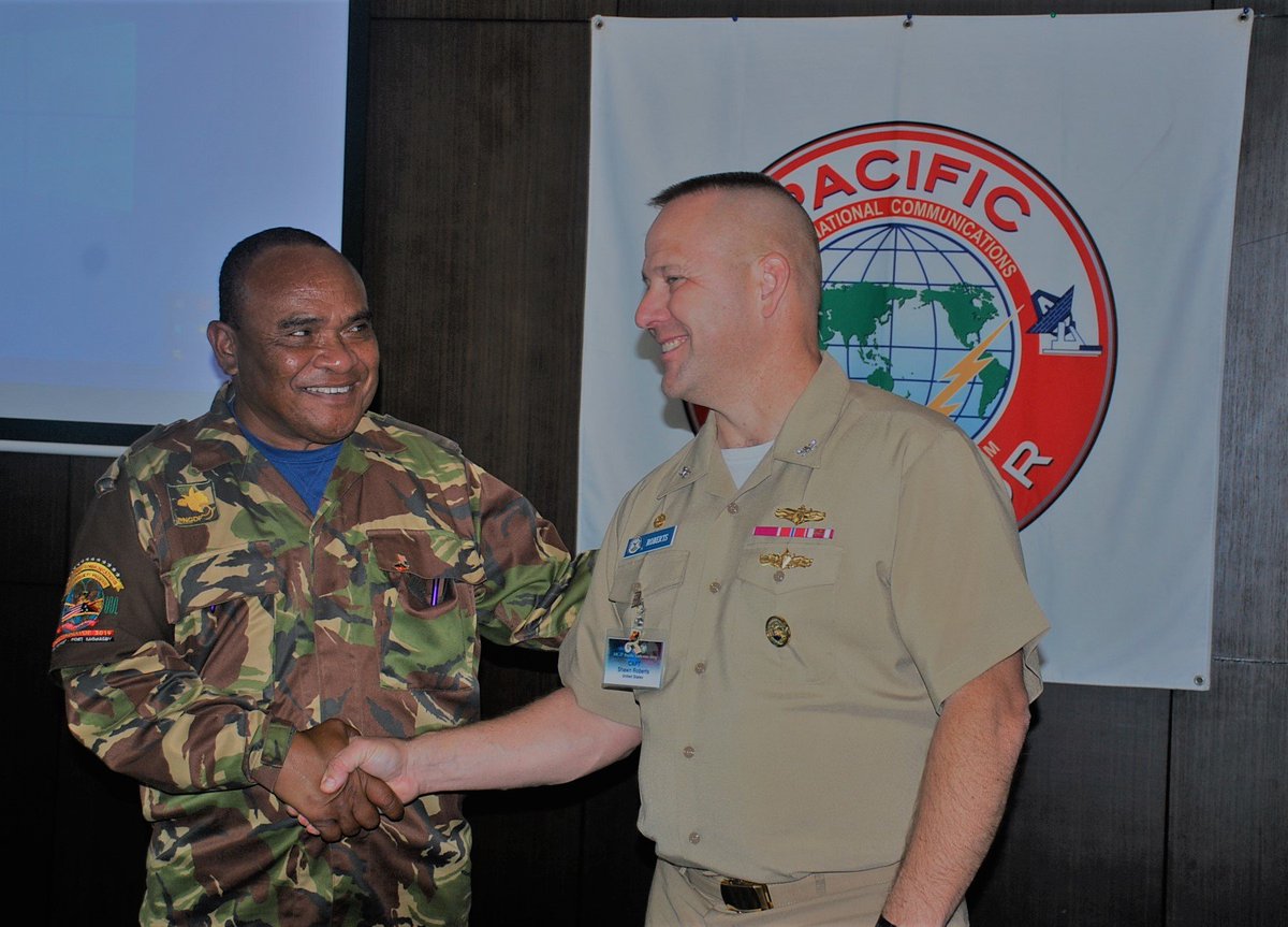 Captain Shawn Roberts from the #UnitedStatesJointInteroperabilityTestCommand presenting a cap to Lt Col Rupa Tau and a coin to Major Joe Mwawesi from the #PNGDF for the great support so far as the cohost of the #PacificEndeavor19 in Port Moresby.