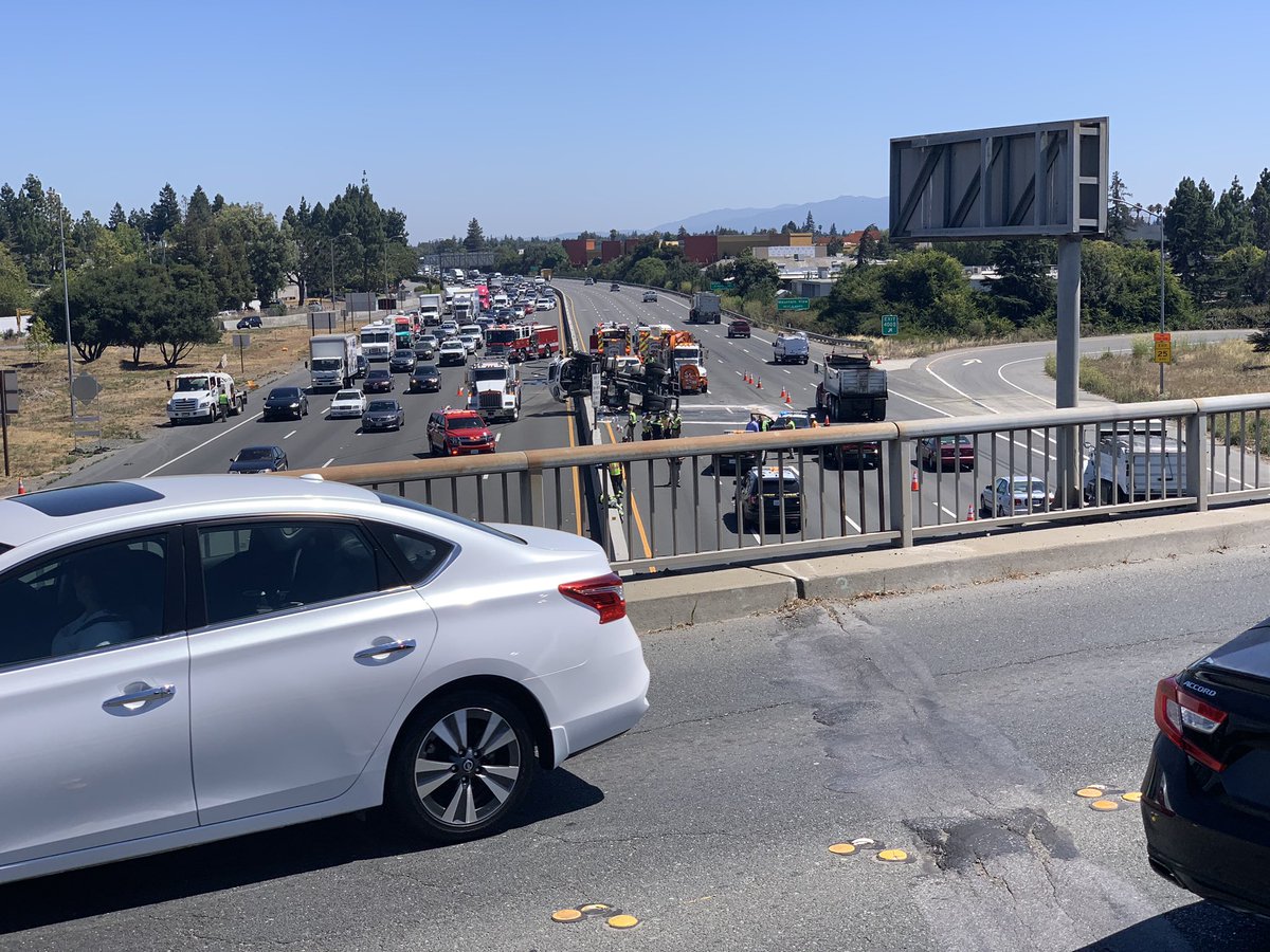 AlexGlanville's tweet photo. Overturned sanitation truck high sided on the center divider right outside of the San Antonio exit in Palo Alto on 101. Lanes 1 and 2 closed both directions. #traffic #accident #news @kron4news #bayarea #freeway #commute https://t.co/K9RzFrH9Wa