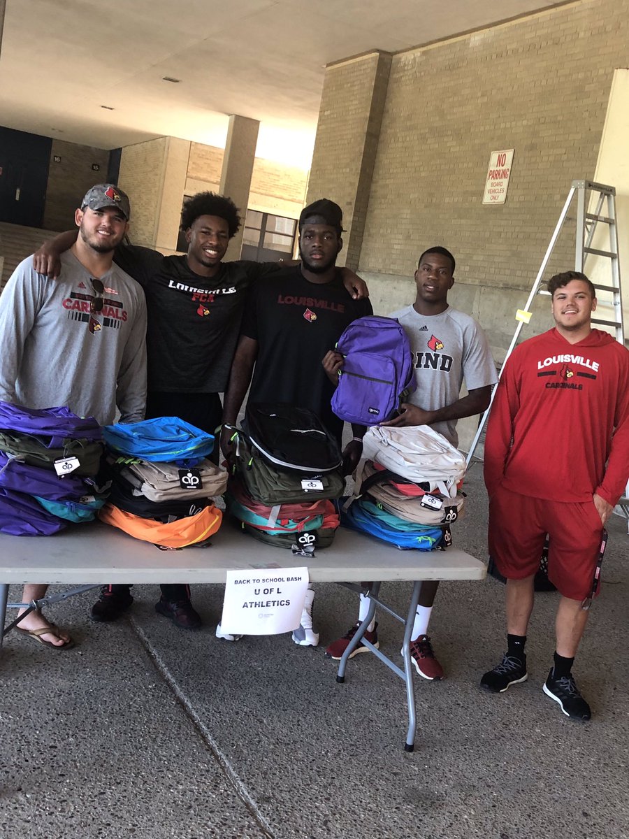 FRCMrsCardwell's tweet photo. It’s report to camp day for the U of L Football players but that didn’t stop them from helping us pass out 1000 back packs to local kids this morning at the BAck to School Bash ❤️ what a group of incredible young men!! https://t.co/lBWKHlydon