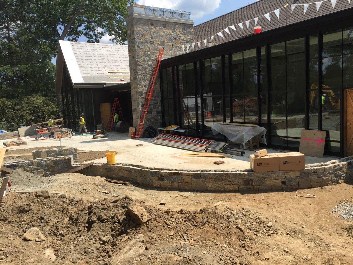 GoGunn1850's tweet photo. Update ALERT #PerakosACC Front Entry seat walls, matching the stonework on the chimney now define the front patio area. Capstones to these walls will be installed to form the seat. Grading of the soils will occur in the coming weeks. #gunnarts #gogunn #progressineducation https://t.co/NSeZljN7cR