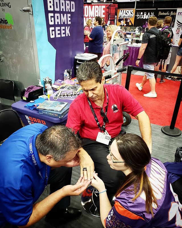 BoardGamerSteph's tweet photo. The #StephandRyanConPic of #gencon this year includes the infamous Podfather Mr. Buonocore of @strongholdgames. @ryanmkb  is the bomb. #bgg #allthegames https://t.co/uea1oXCrMO https://t.co/roqOO9ohfl