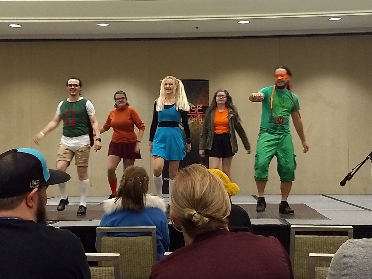 Talkos's tweet photo. Just a few picture highlights from Gencon. The awesome nerds of @CosplayTapDance showing the 90s never died and last night's intrepid band of writers....before any dwarves are thrown in ponds or javelins tossed into backs. https://t.co/rDL5rzOFp5