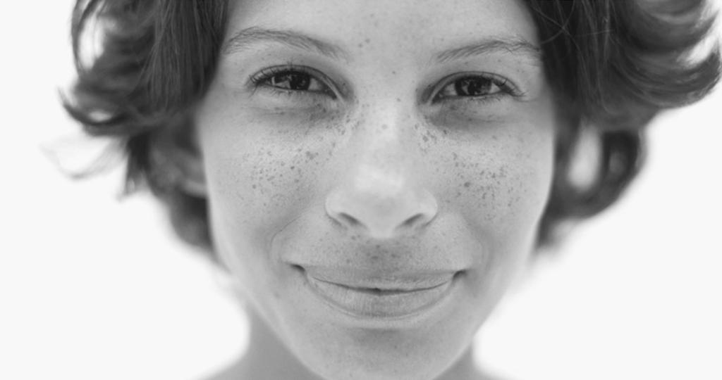 smiling woman with freckles black and white