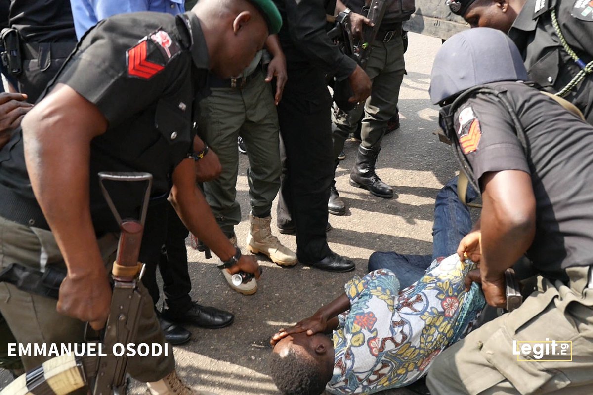 Kofi_Bartels's tweet photo. I watched on TV as police dragged this @SaharaReporters staff into a detention truck despite his claim that he was a journalist during, #RevolutionNow. The pictures show something is being sprayed on his face by a policeman as he lays helpless on the ground. This is wrong! https://t.co/LMCSwQ9MyM