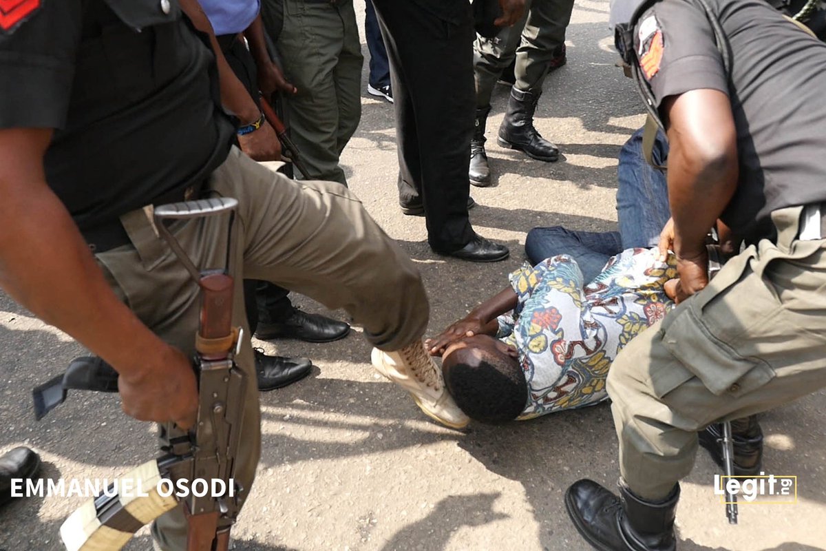 Kofi_Bartels's tweet photo. I watched on TV as police dragged this @SaharaReporters staff into a detention truck despite his claim that he was a journalist during, #RevolutionNow. The pictures show something is being sprayed on his face by a policeman as he lays helpless on the ground. This is wrong! https://t.co/LMCSwQ9MyM