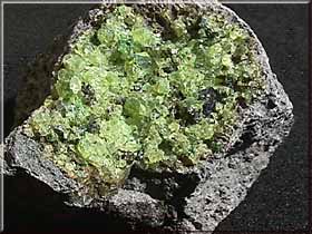 USGS's tweet photo. Anyone born in the month of August?  Peridot is your birthstone, which is the gem variety of olivine, pictured here. #MineralMonday https://t.co/zDseF3M8an
