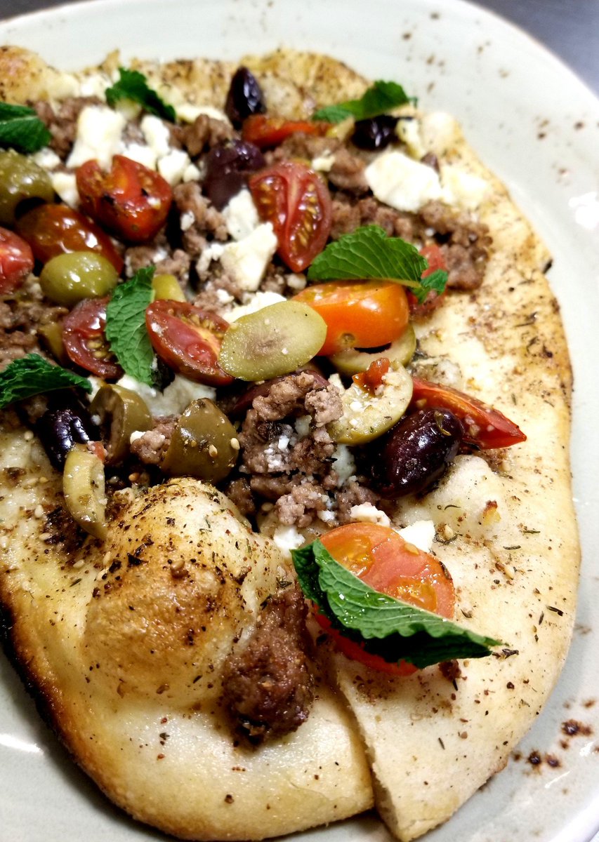 Lamb Man'oushe - Thin Flat Bread / Ground Colorado Lamb / Corto EV Olive Oil / Fresh Ground Za'atar Spice / Heirloom Tomatoes / Olives / Feta / Mint