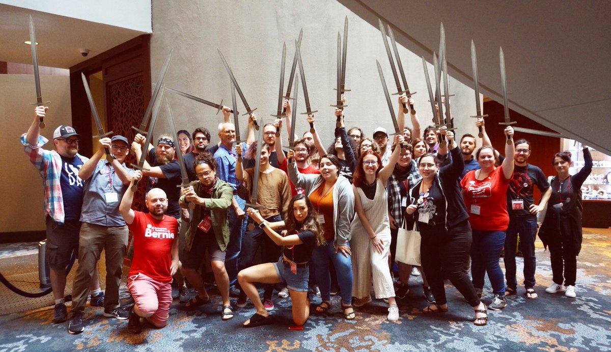 Portland DSA delegates pose for a photo with all their swords in the hotel lobby.