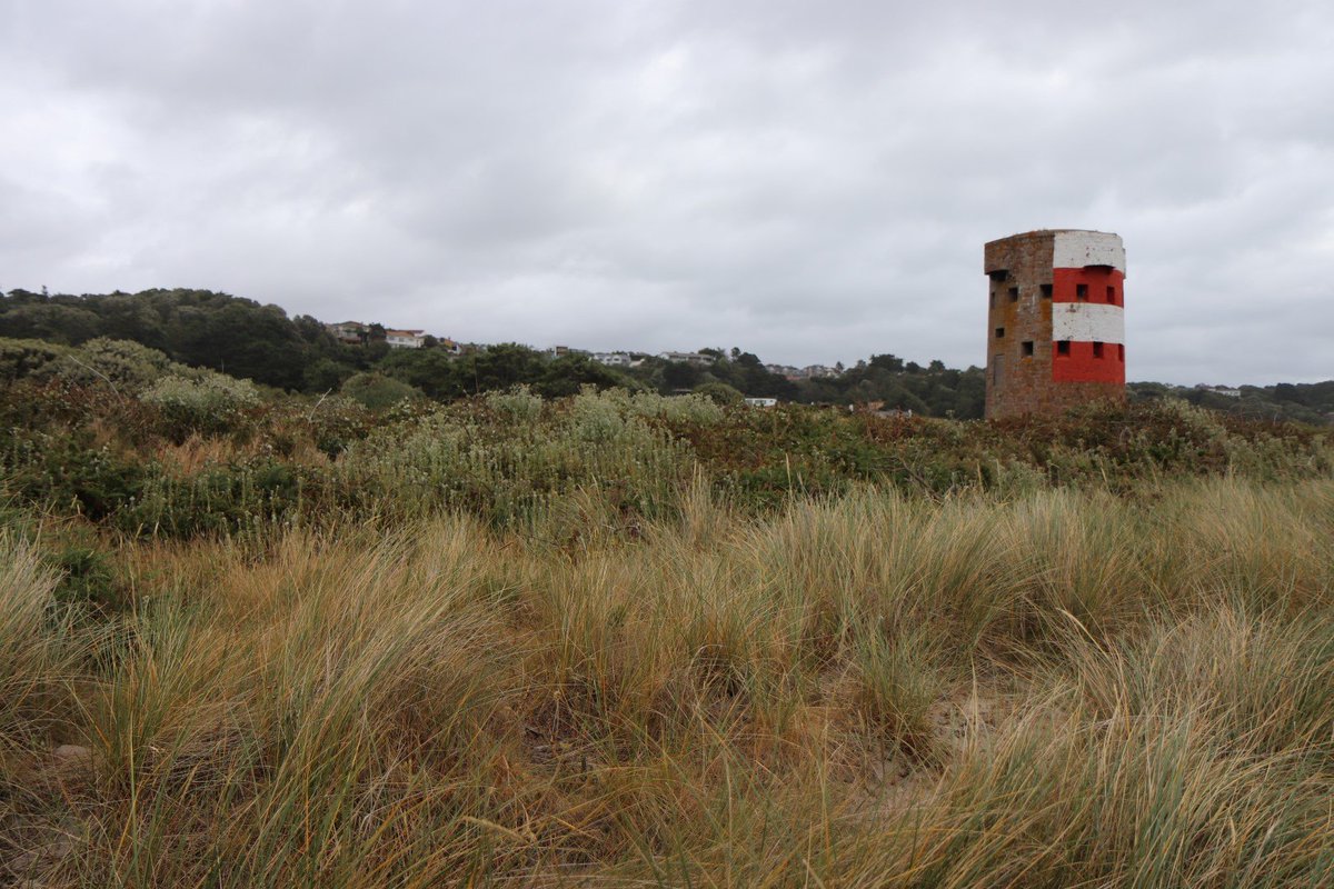 A coastal tower in St Brelade, Jersey braced for the incoming storm. Built in the late 18th Century and now partly painted red and white to aid navigation on the sea #coastalarchitecture #Conwaytower #lovearchitecture