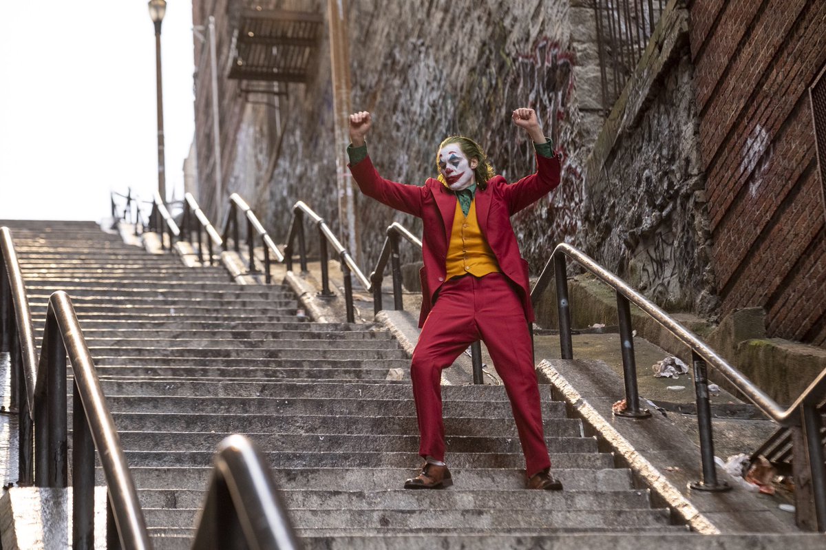 IMDb's tweet photo. Let’s put a smile on that face with the latest stills from #JokerMovie 🃏 https://t.co/OGX8MVeAn6 https://t.co/fIUrT7C2Pw