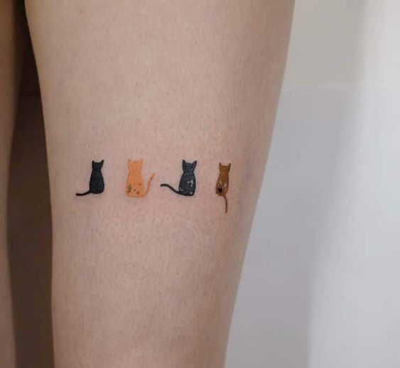Minimalist cat tattoo on the inner arm.