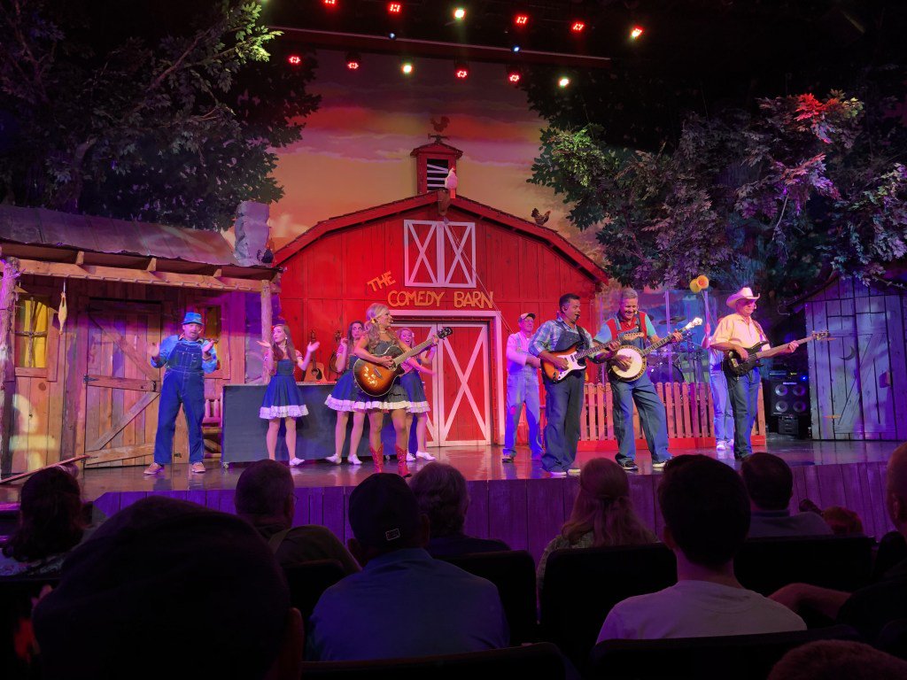 theSMMomblog's tweet photo. The Comedy Barn has been a well known landmark on the Parkway in Pigeon Forge for the last 25 years. You can't miss seeing the big red barn, located just in front of the Island. And you can't miss going to the show! Here is why: https://t.co/SlKK9h55G6 https://t.co/85F3t9S53I