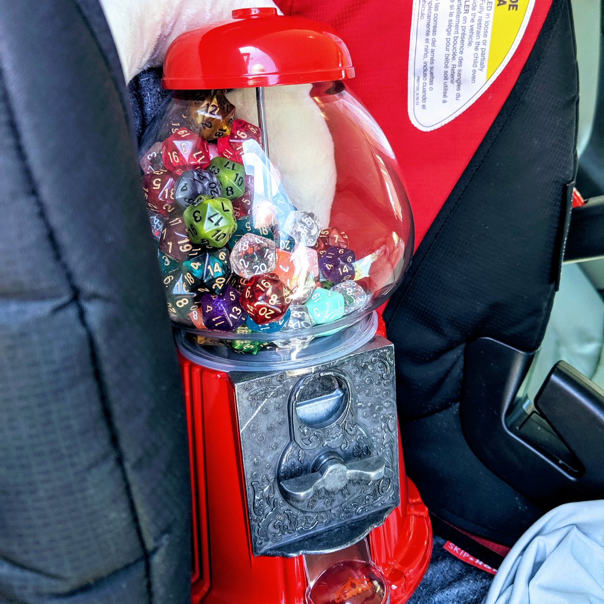Darbosama's tweet photo. Filled a gumball machine with twenty-sided dice and drove it to a bar in a baby seat. My life has become strange. https://t.co/c6fFNgFbpp